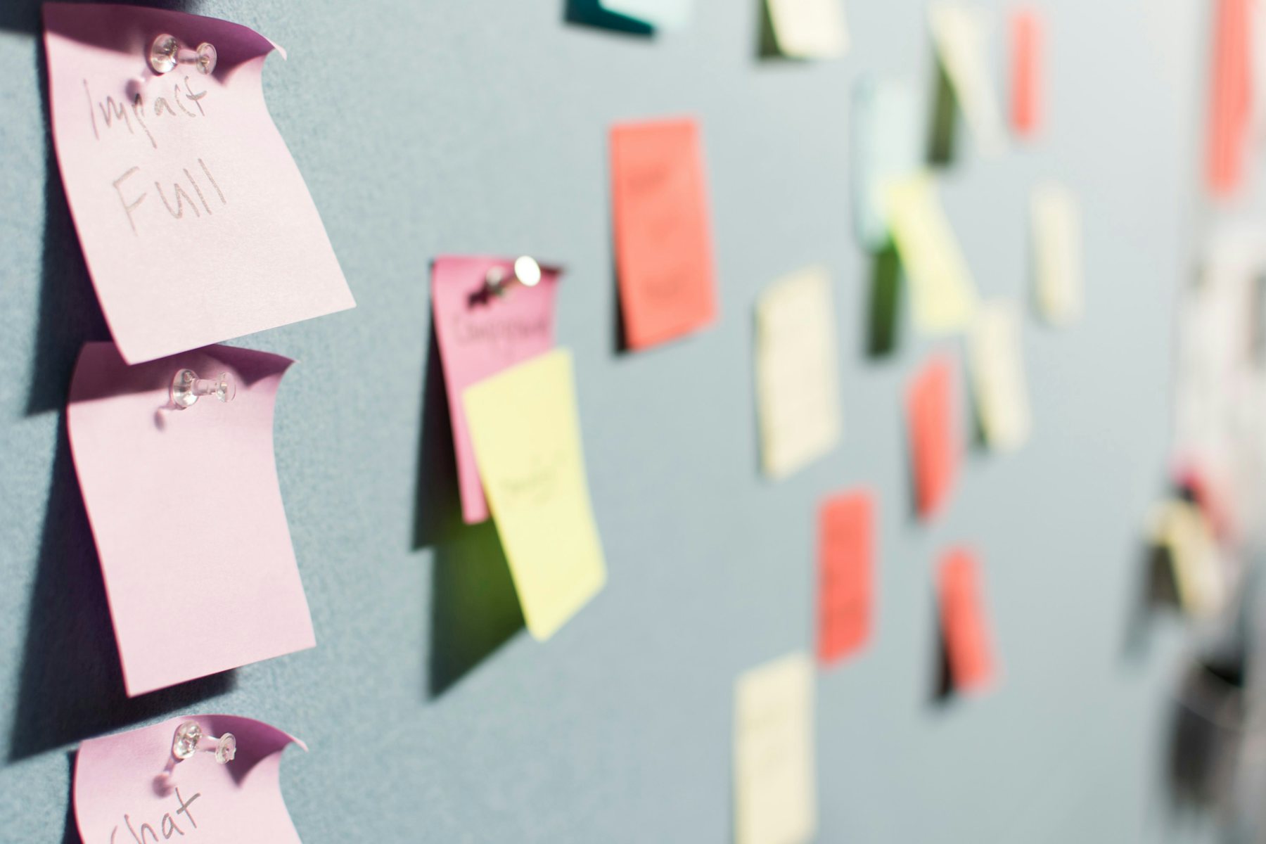Notes pinned to a wall during team planning